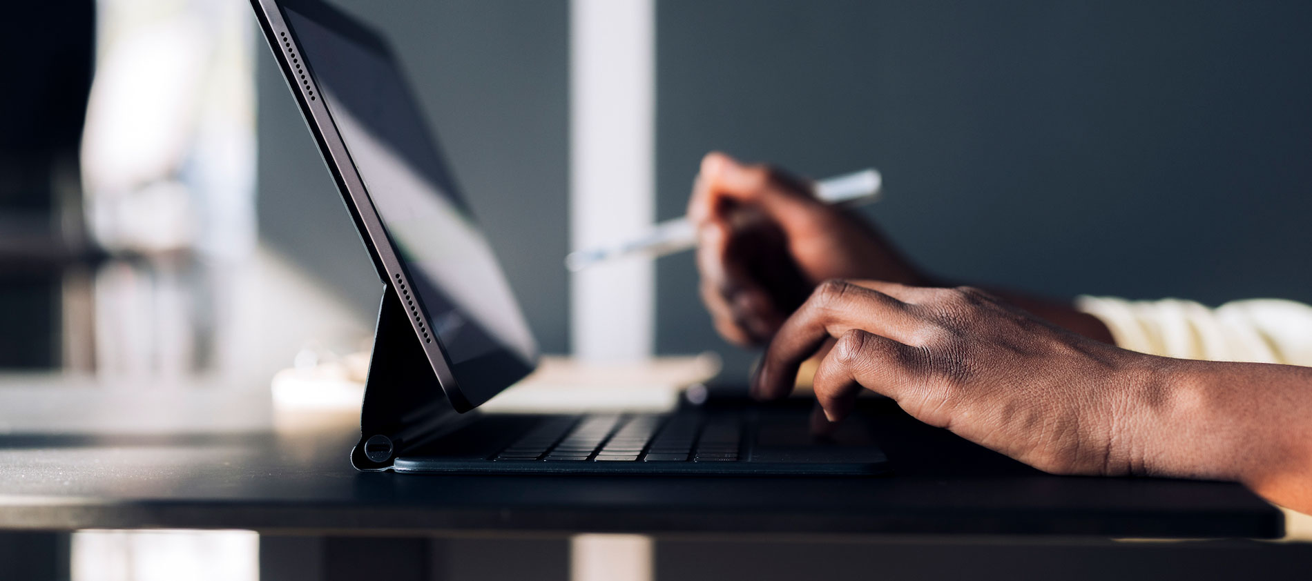 Hands typing on a laptop investigating the online JBI Critical Appraisal Tools