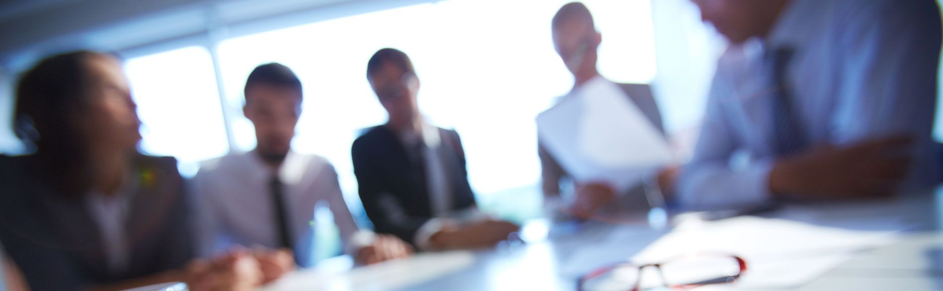 Blurry image of a group of people working around a table