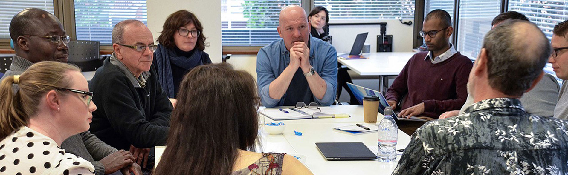 Students sitting around a table at a JBI training session